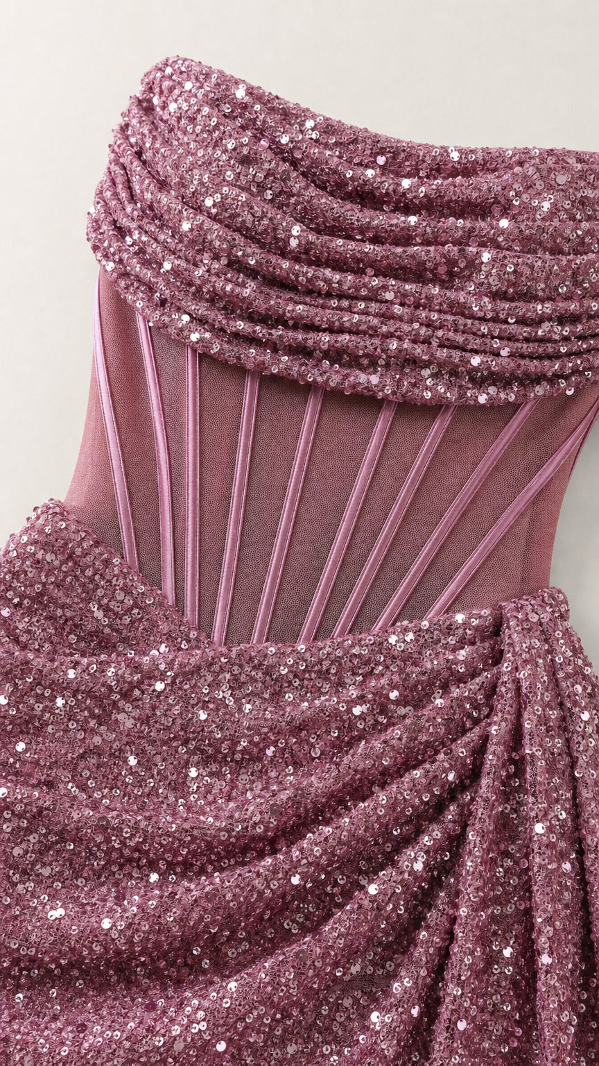 Close-up detail of draped strapless neckline and sheer boned corset