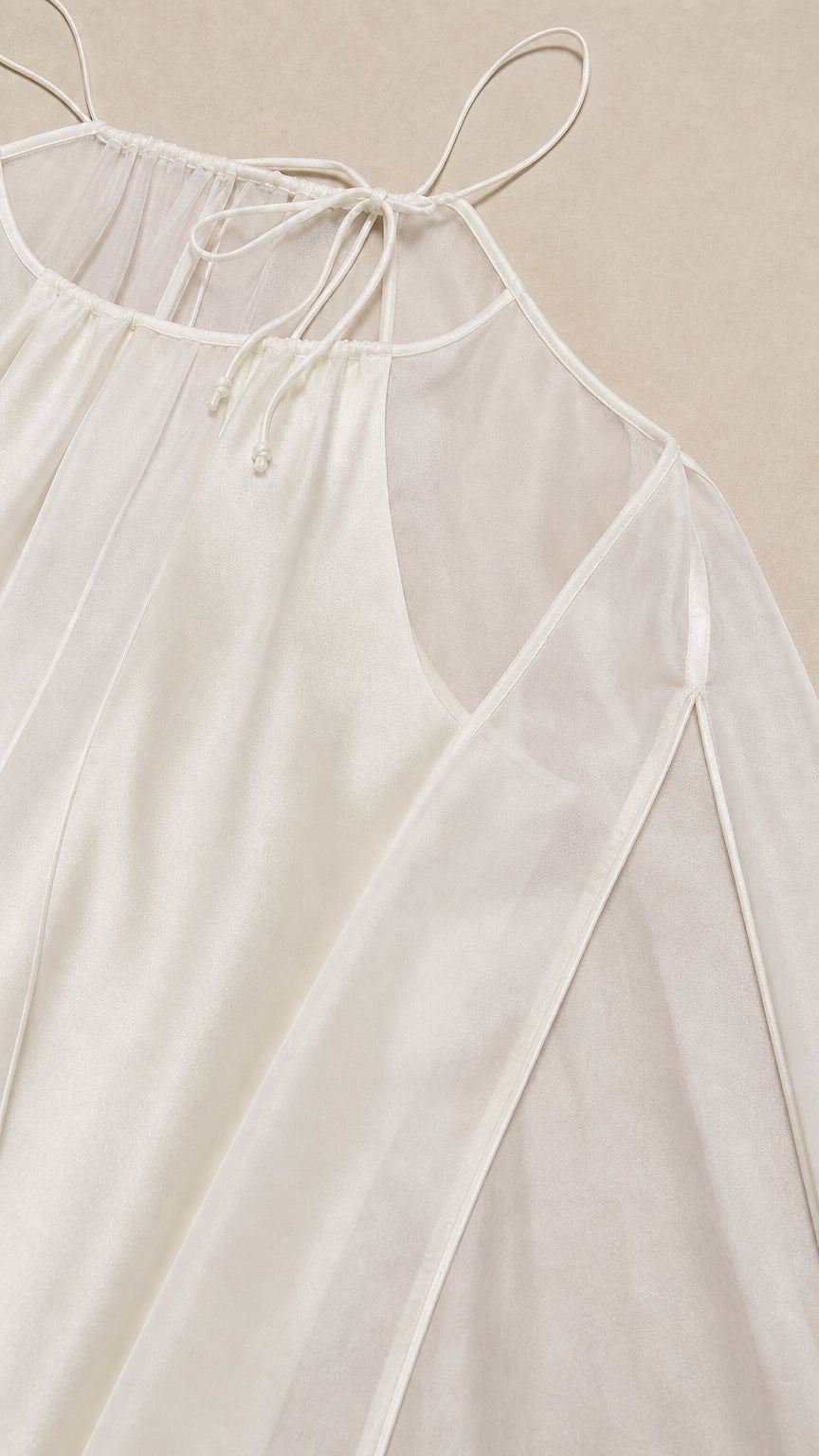 Close-up detail of halter neckline and fabric texture in ivory