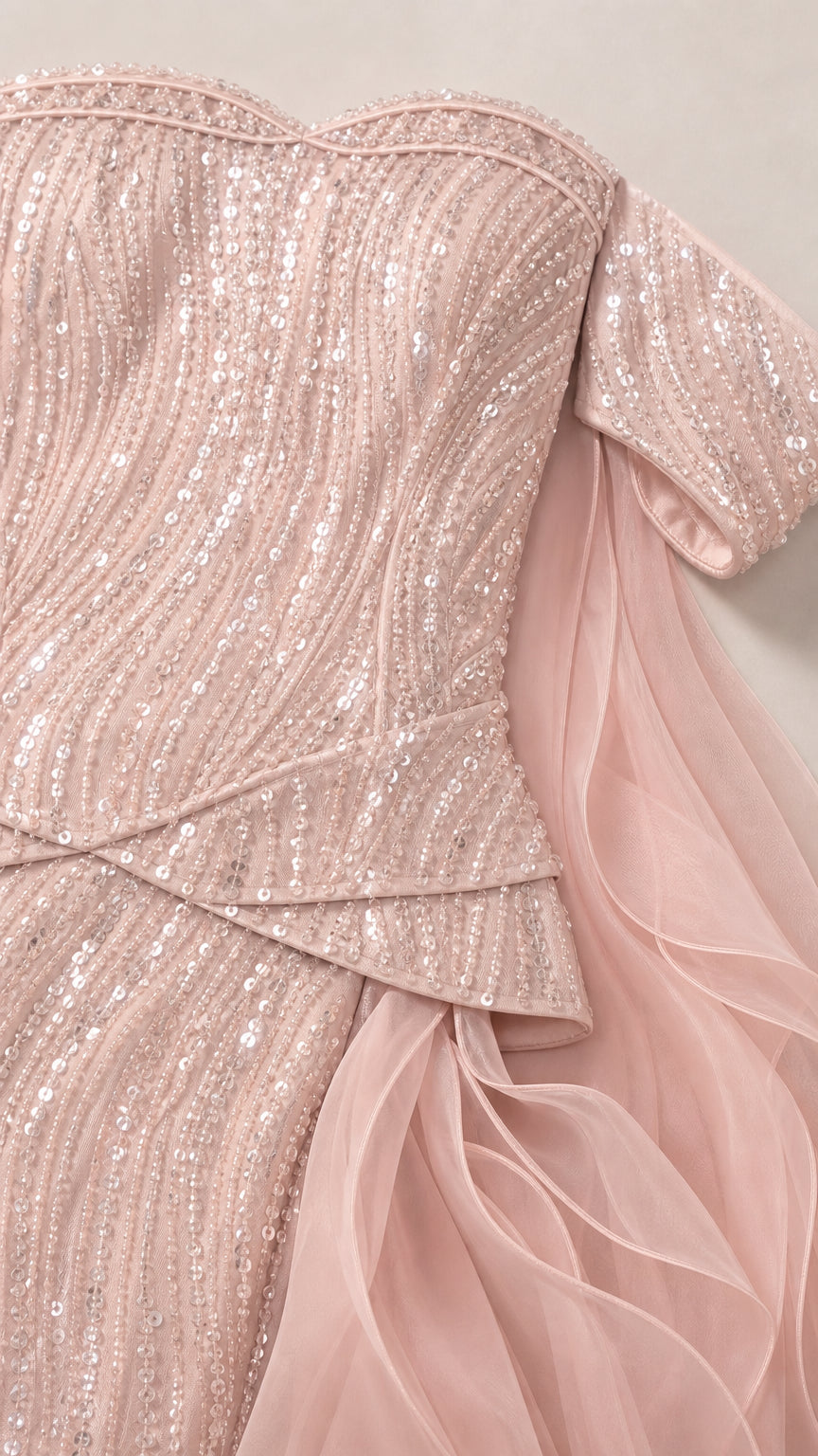 Close-up detail of sequin texture and draped waist on pink dress