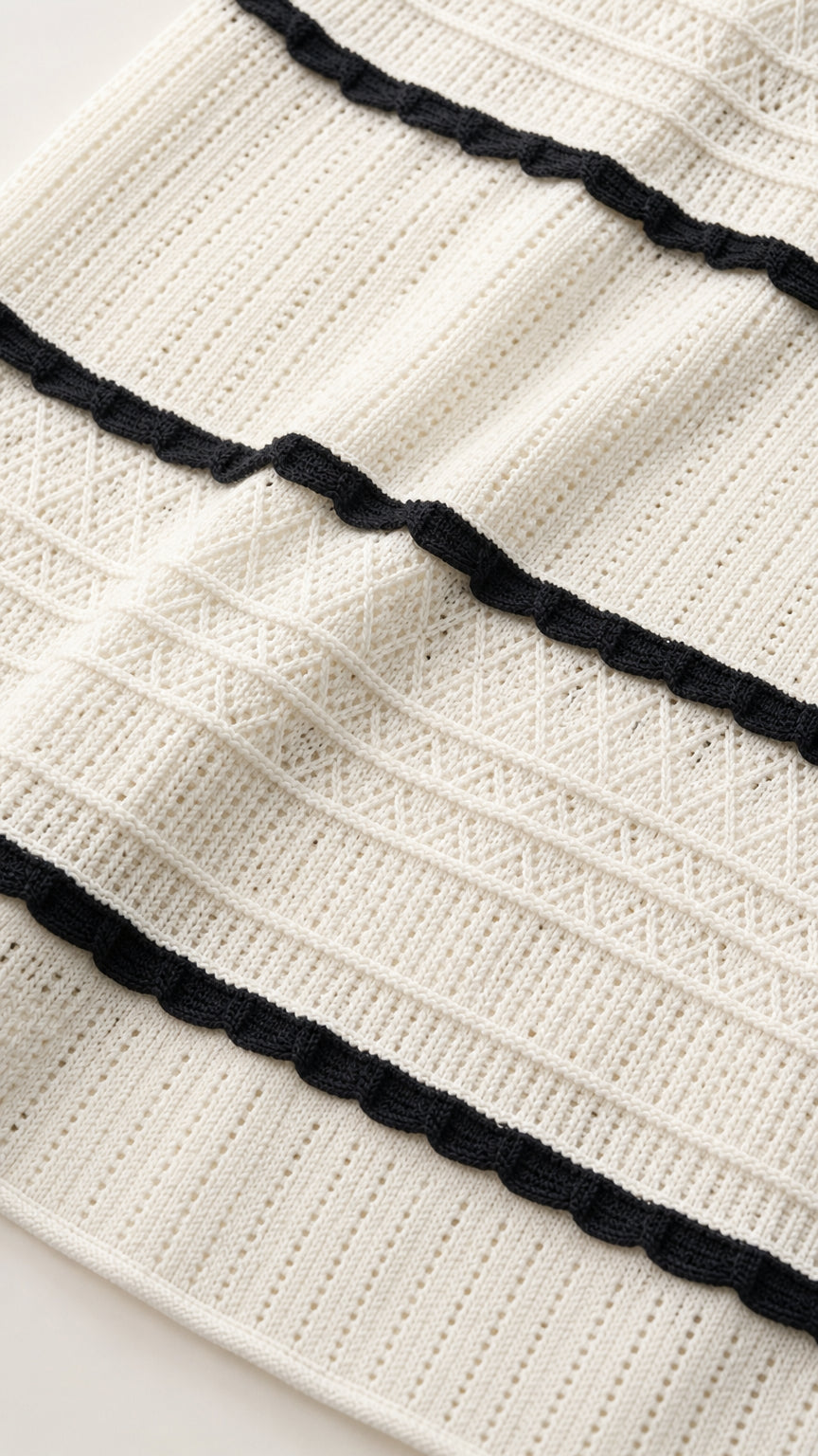 Close-up detail of white and black striped ribbed knit fabric