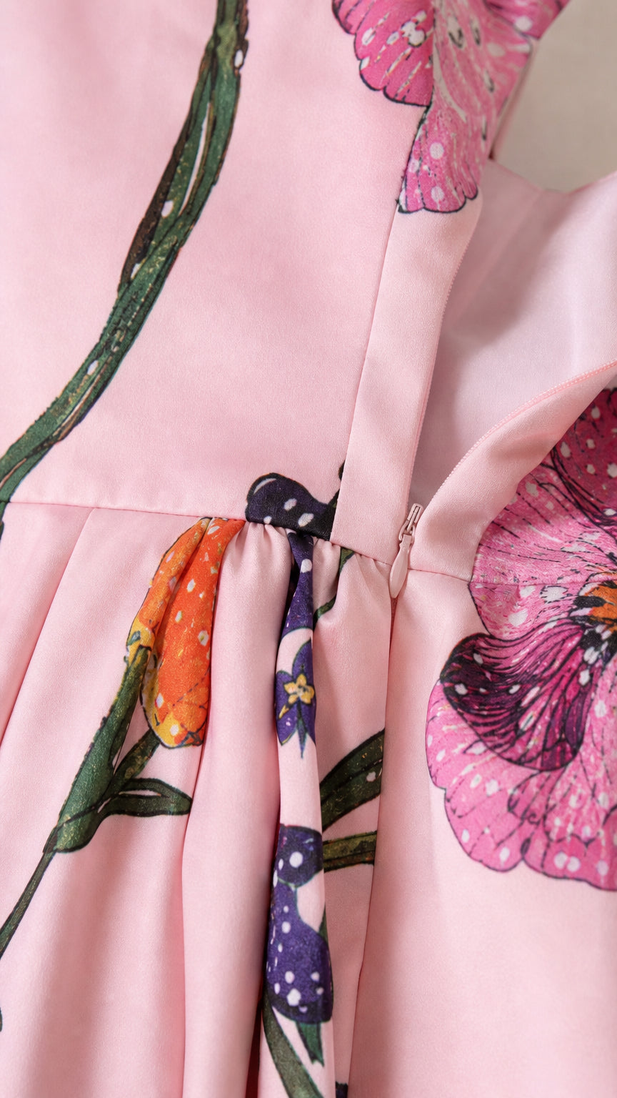 Close-up of dress fabric, floral print, and zipper detail