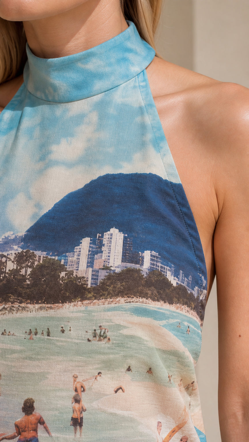 Close-up detail of blue coastal graphic on mock neck top