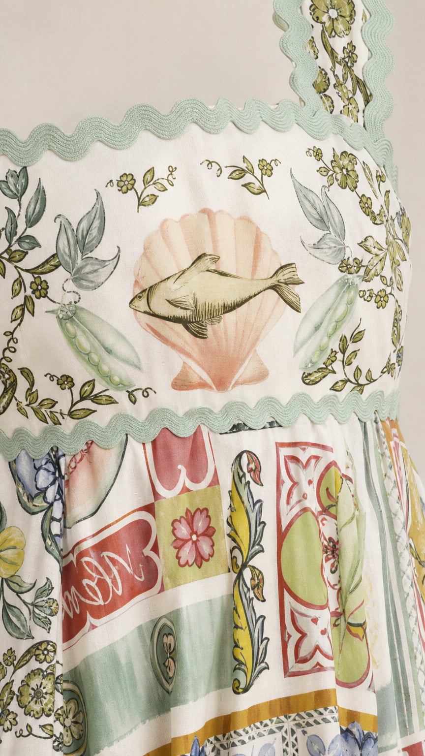 Close-up detail of shell embroidery and scalloped trim