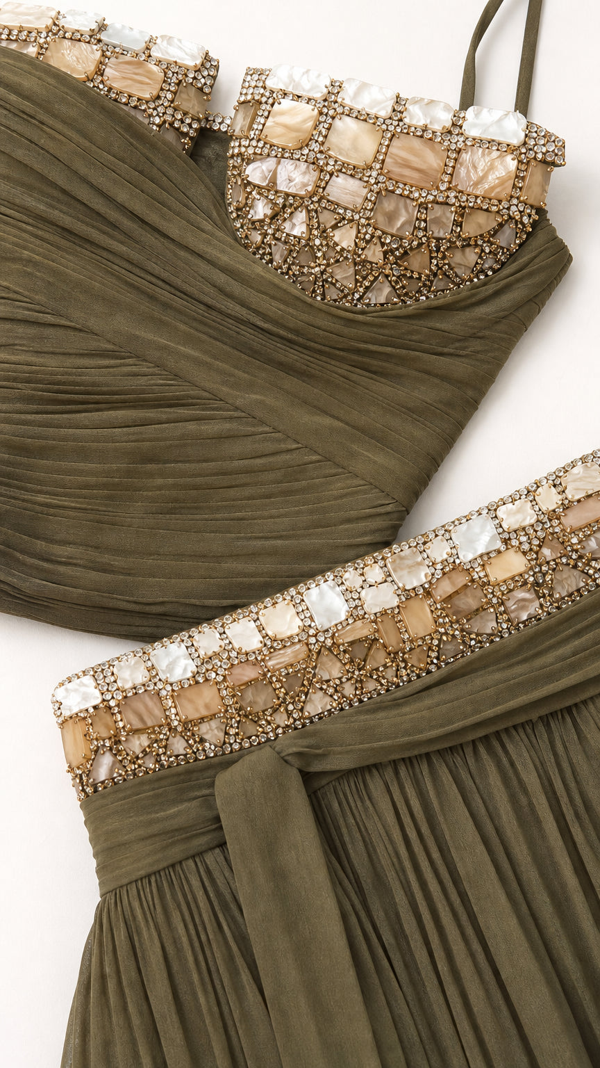 Close-up detail of embellished stonework on neckline and waistband