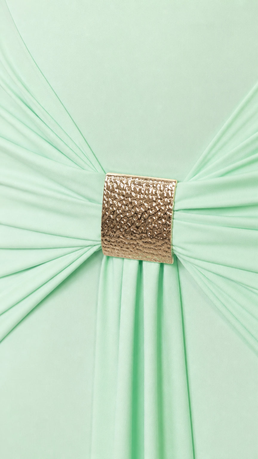 Close-up of gold metallic buckle gathering fabric on the dress