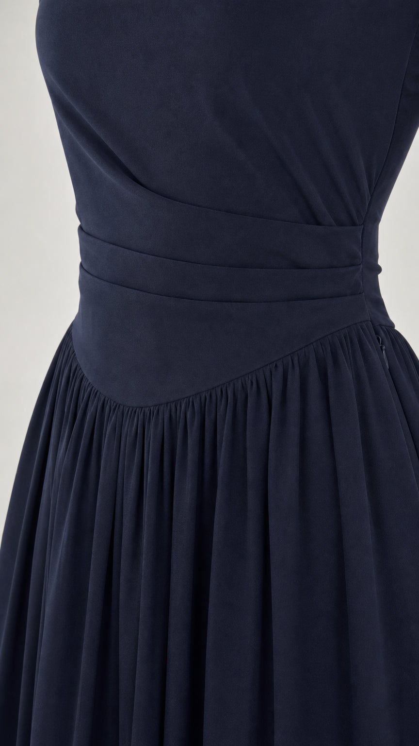 Close-up detail of pleated waistband on Navy chiffon dress