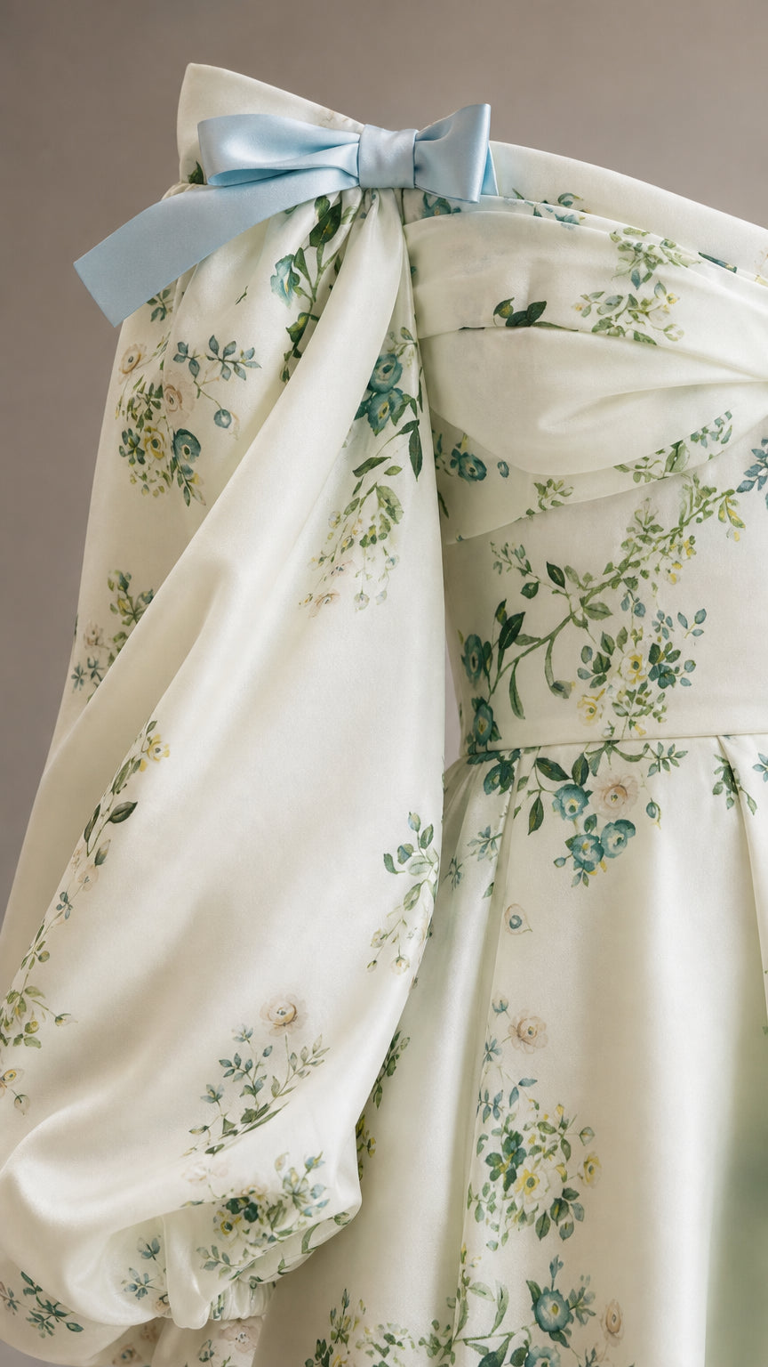 Close-up detail of bow accent and floral fabric on dress
