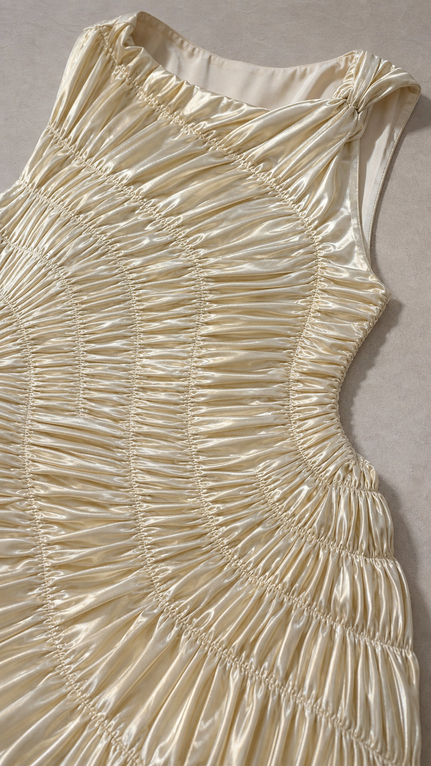 Close-up detail of bodice smocked ruching on champagne dress