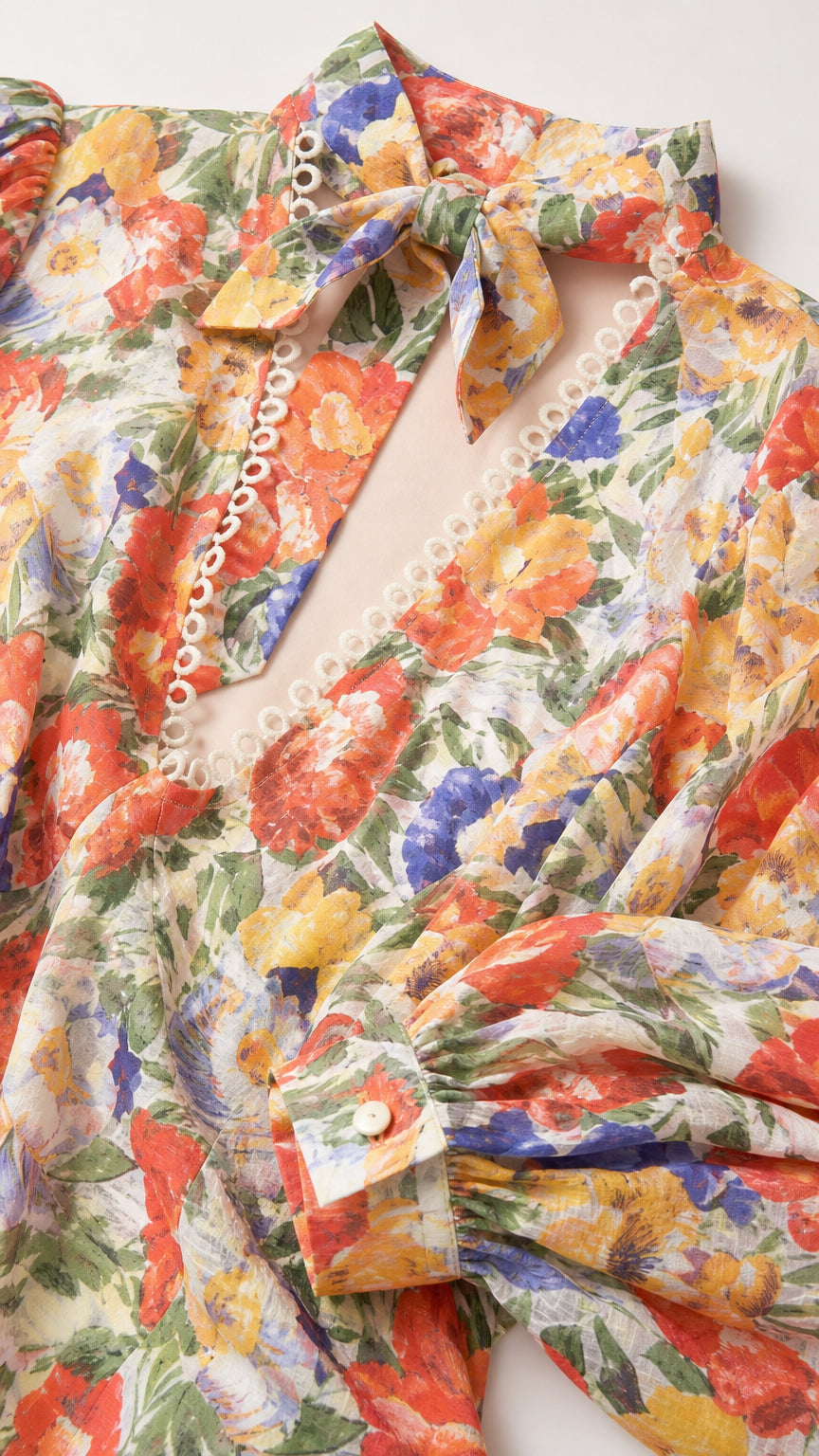 Close-up detail of fabric, buttons, and neck scarf