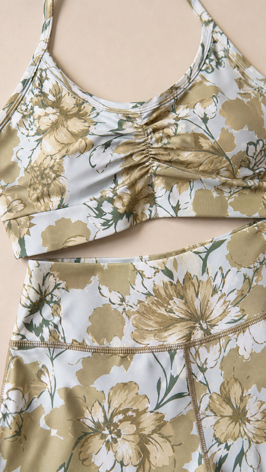 Close-up detail of sage green floral crop top and leggings waistband