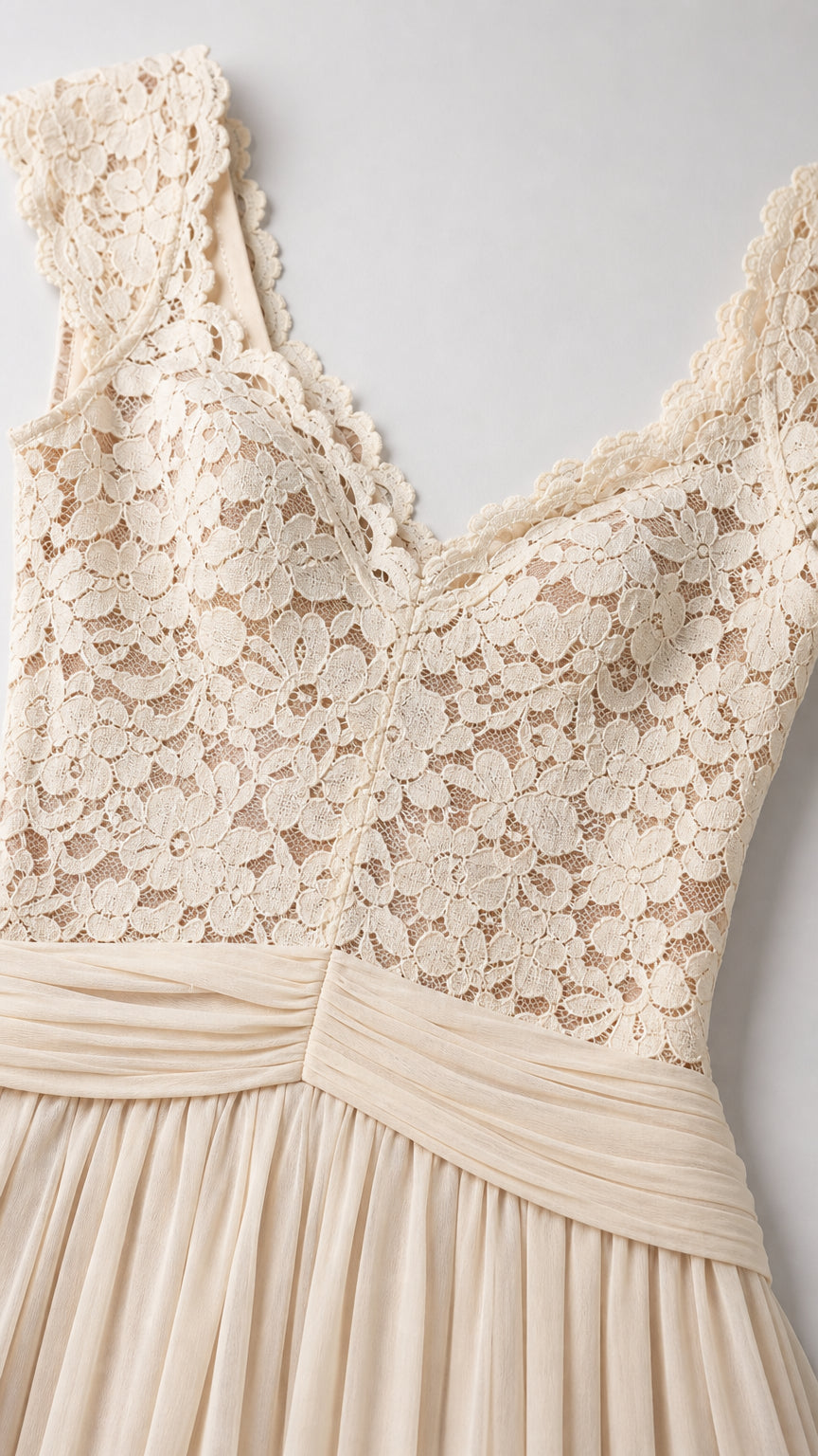 Close-up detail of lace V-neck bodice and pleated waistband