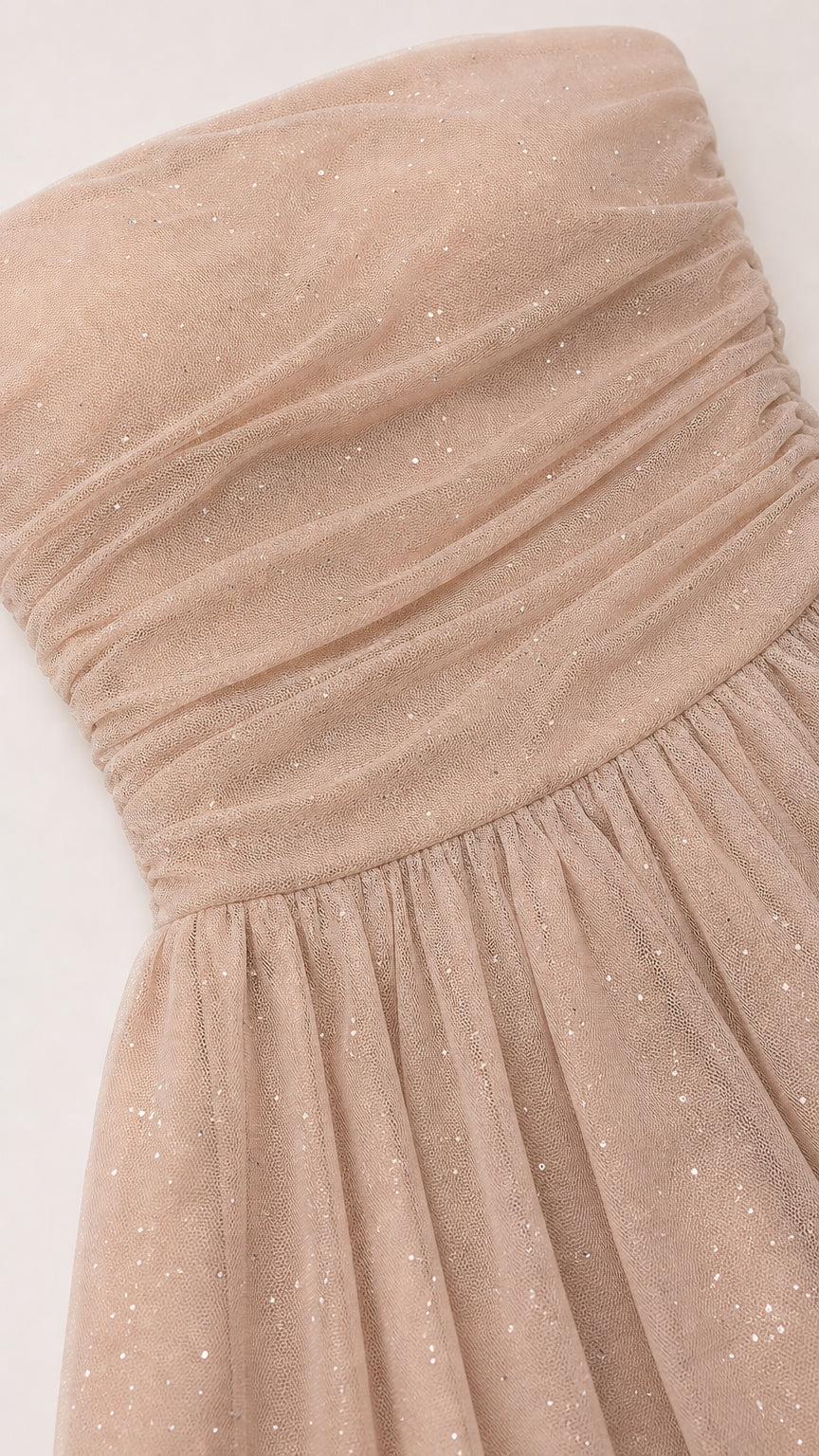 Close-up detail of ruched bodice and glitter mesh texture