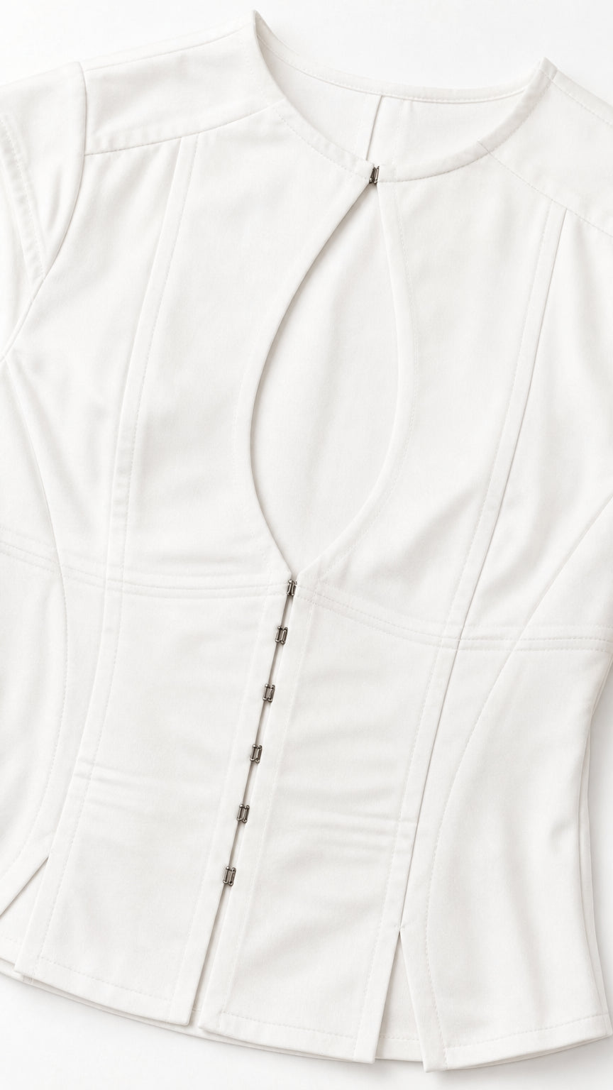 Close-up detail of white corset top keyhole and hook closures