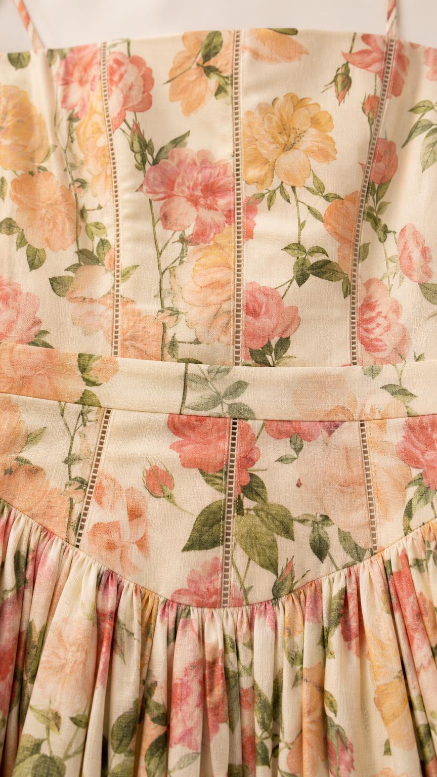 Close-up detail of bodice and gathered waist on cream floral dress