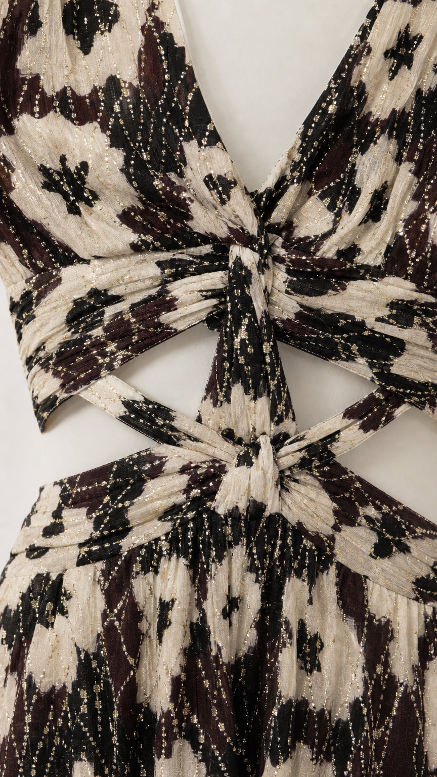 Close-up detail of V-neckline and waist cutout on black floral dress