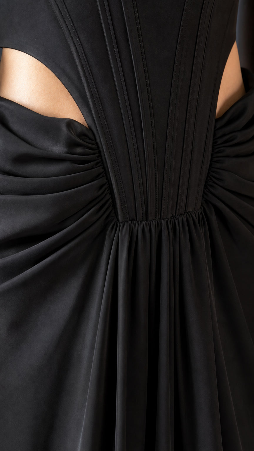 Close-up of waist cutouts and pleated bodice construction