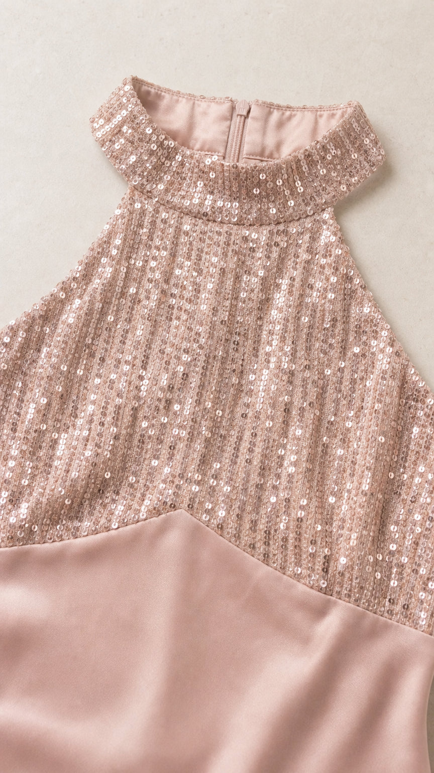 Close-up detail of sequin halter neckline and satin fabric