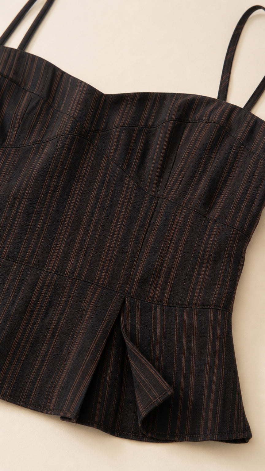 Close-up detail of the black striped camisole fabric and construction