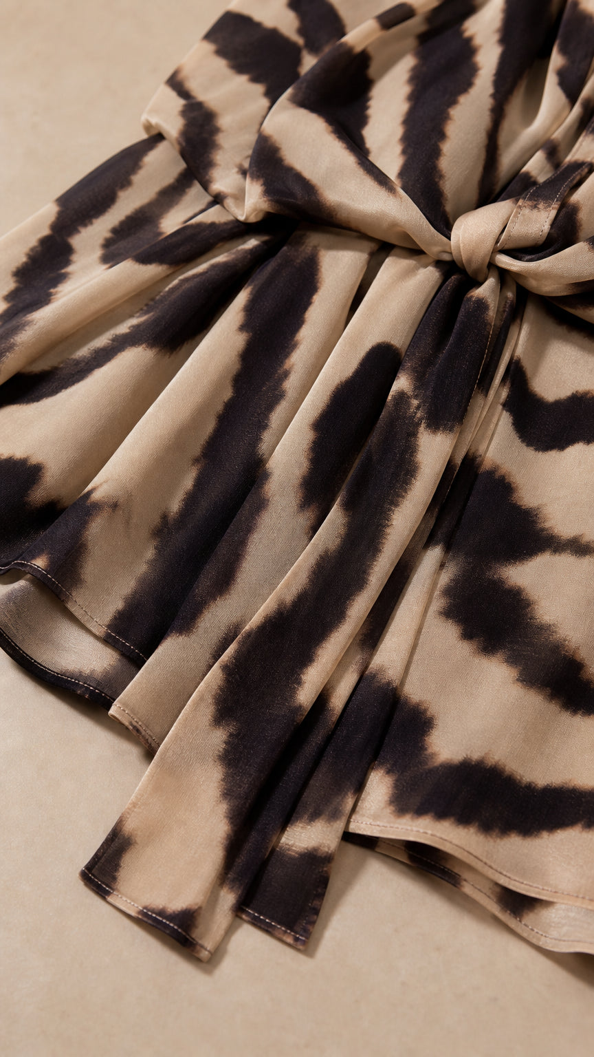 Close-up detail of fabric, pattern, and waist tie