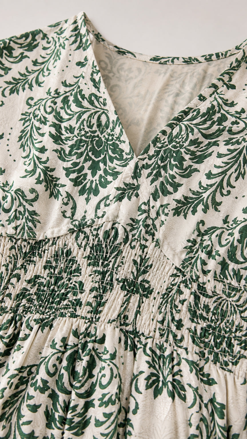 Close-up of V-neck and smocked bodice detail