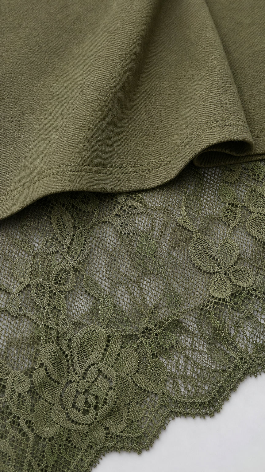 Close-up of olive knit fabric meeting sheer floral lace skirt