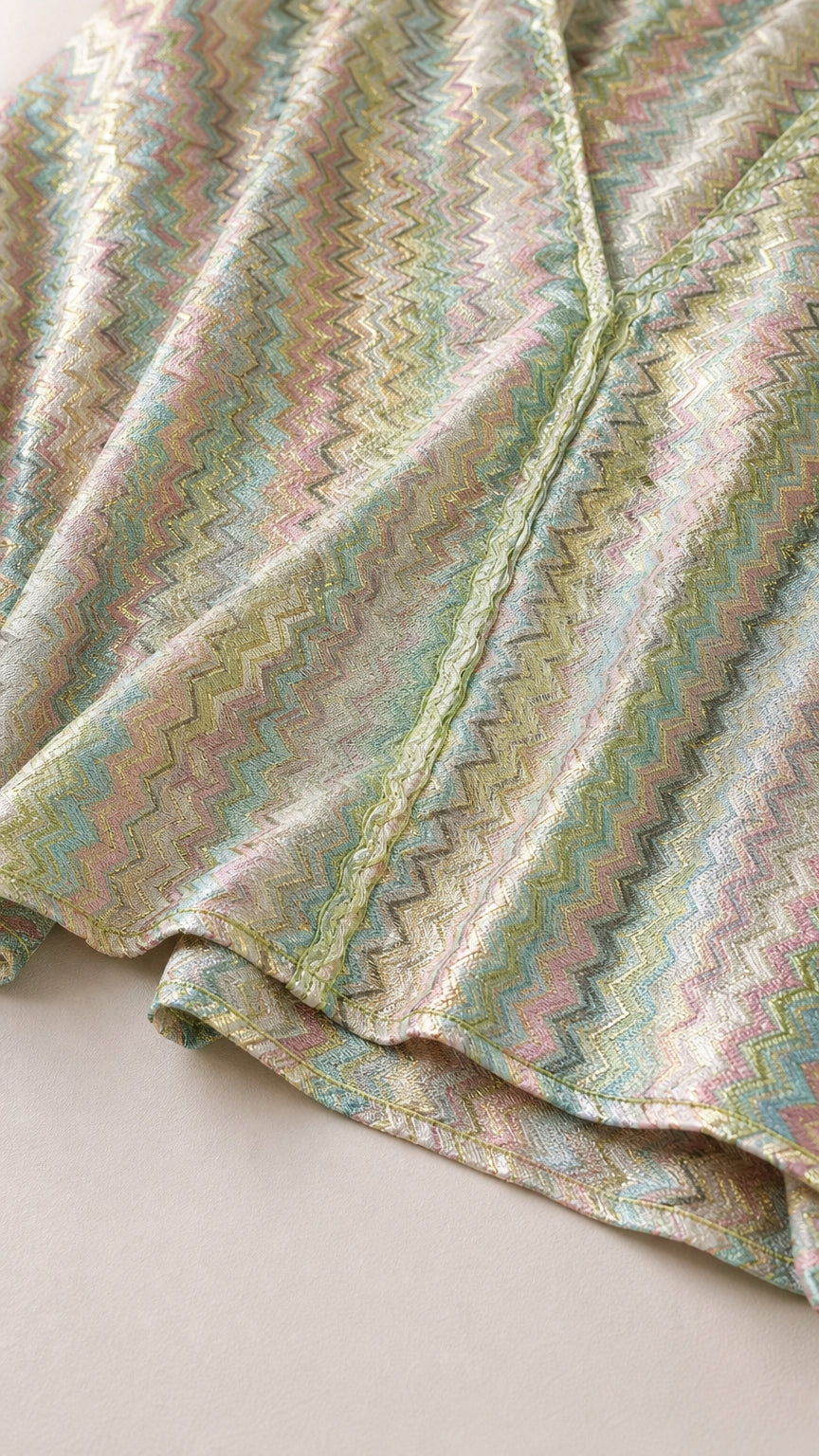 Close-up detail of the metallic chevron knit fabric and hem