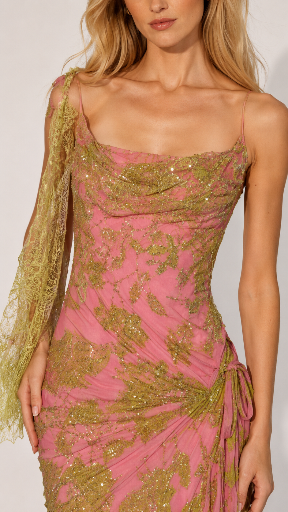 Close-up of pink cowl neckline glitter mesh gown with side ruching detail