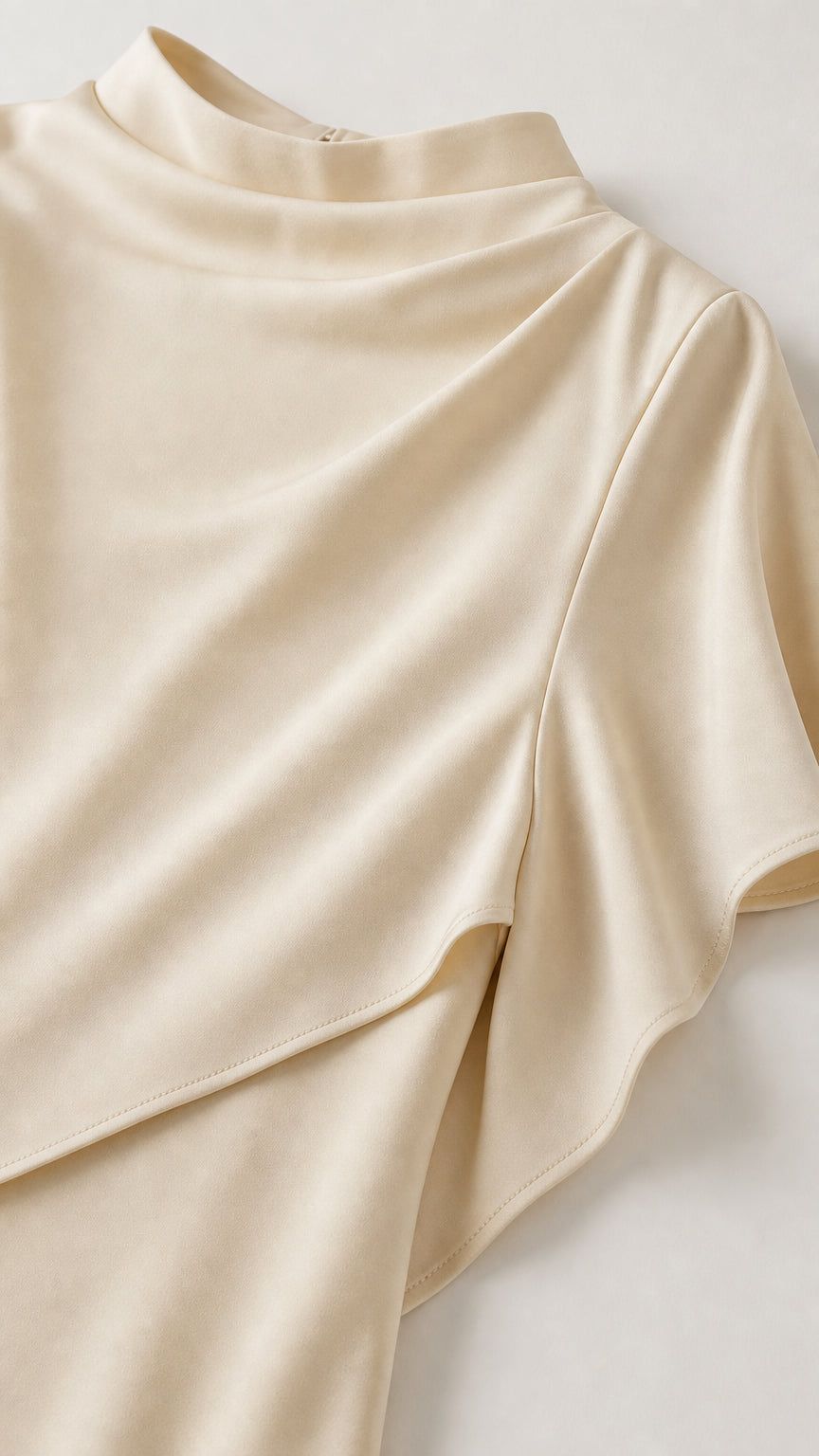 Close up detail of the mock neck and draped overlay fabric