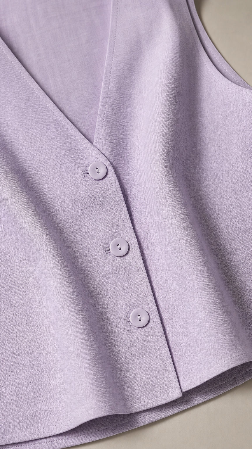Close-up detail of lavender vest buttons and fabric texture