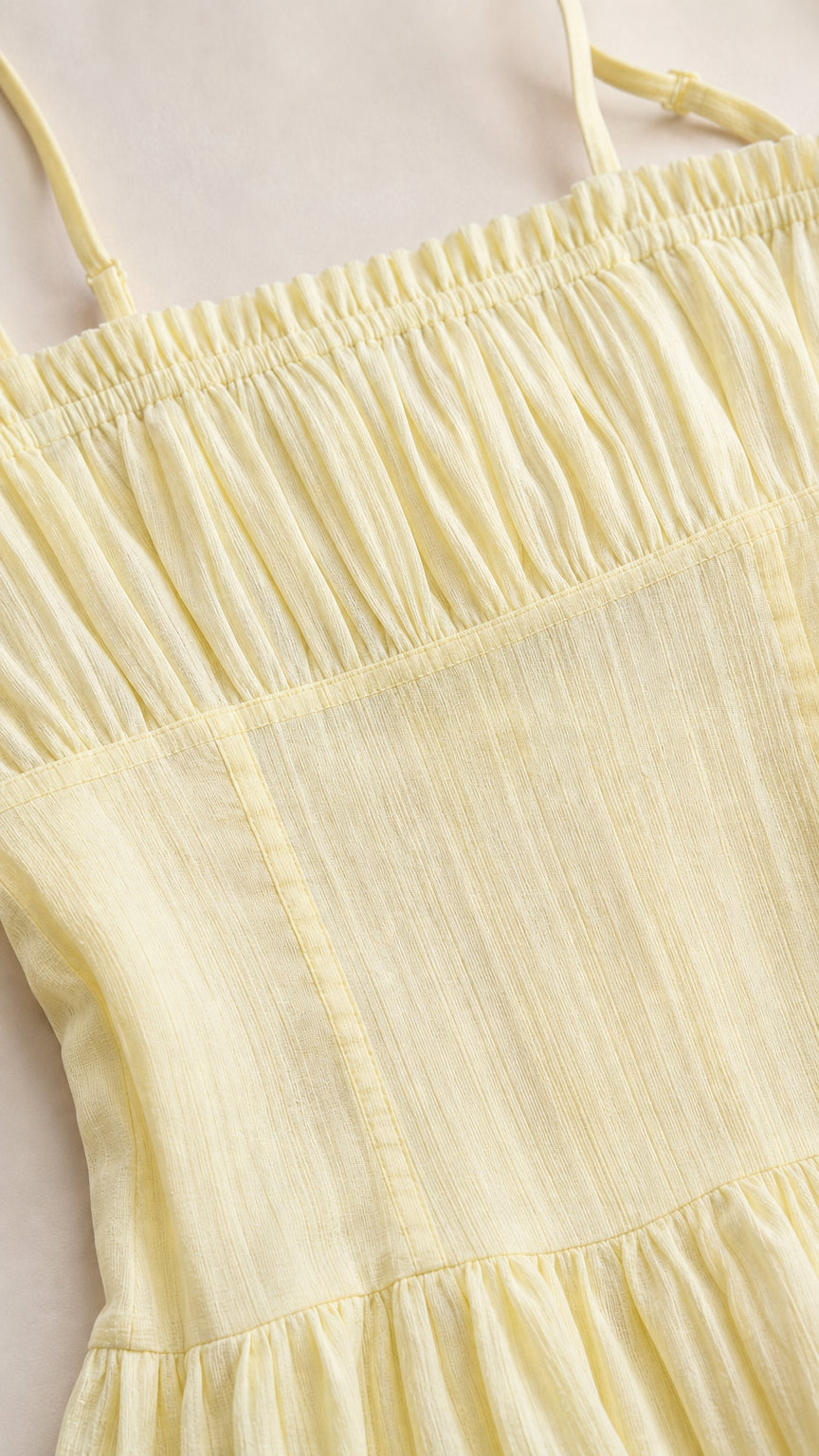 Close up of smocked bodice on yellow midi dress